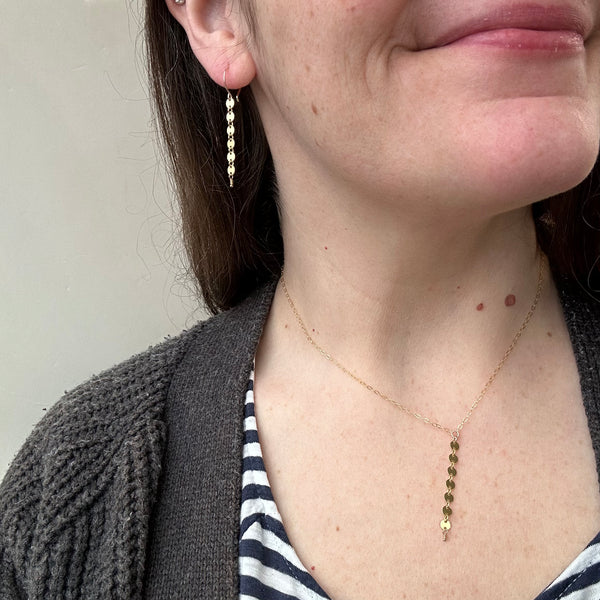 pieces_of_eight_necklace_y_necklaces_coin_dangle_chain_necklace_custom_chains_gold_filled_sustainable_jewelry_on_model_matching_earrings