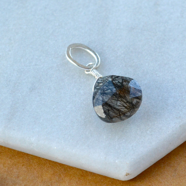 Black Sea Tourmalinated Quartz gemstone pendant necklace gemstone charm for charm bracelet necklace for charms for necklaces silver black rutilated quartz gem pendant black striped gem wire wrapped in silver with oval pendant loop displayed on white marble