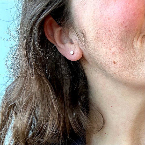 Petite Speckle Stud Earrings 4mm disc stud ear rings handmade hammered posts sterling silver on model