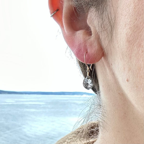 wayfinder earrings handmade gemstone earring tourmalinated quartz black earrings hexagon shape earring gold fill sustainable earrings rutilated quartz on model